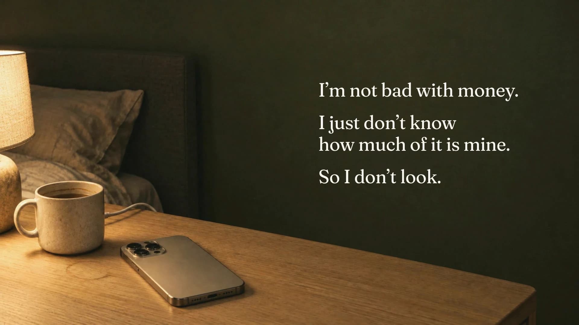 A phone lies face-down on a bedside table at night beside the words: I just don't know how much of it is mine. So I don't look.